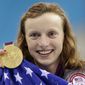 United States&#39; Katie Ledecky holds up her gold medal after winning the women&#39;s 800-meter freestyle swimming final at the Aquatics Centre in the Olympic Park during the 2012 Summer Olympics in London, Friday, Aug. 3, 2012. (AP Photo/Lee Jin-man)