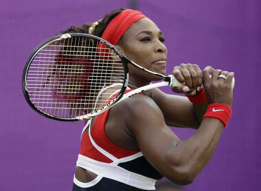 Serena Williams of the United States returns a shot to Caroline Wozniacki of Denmark at the All England Lawn Tennis Club at Wimbledon, in London, at the 2012 Summer Olympics, Thursday, Aug. 2, 2012. (AP Photo/Mark Humphrey)