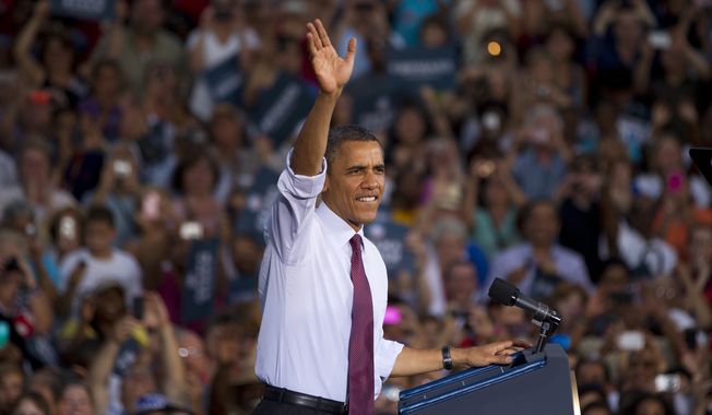 President Obama greets the crowd after arriving for a campaign stop at Loudoun County High School on Thursday, Aug. 2, 2012, in Leesburg, Va. (AP Photo/Evan Vucci)