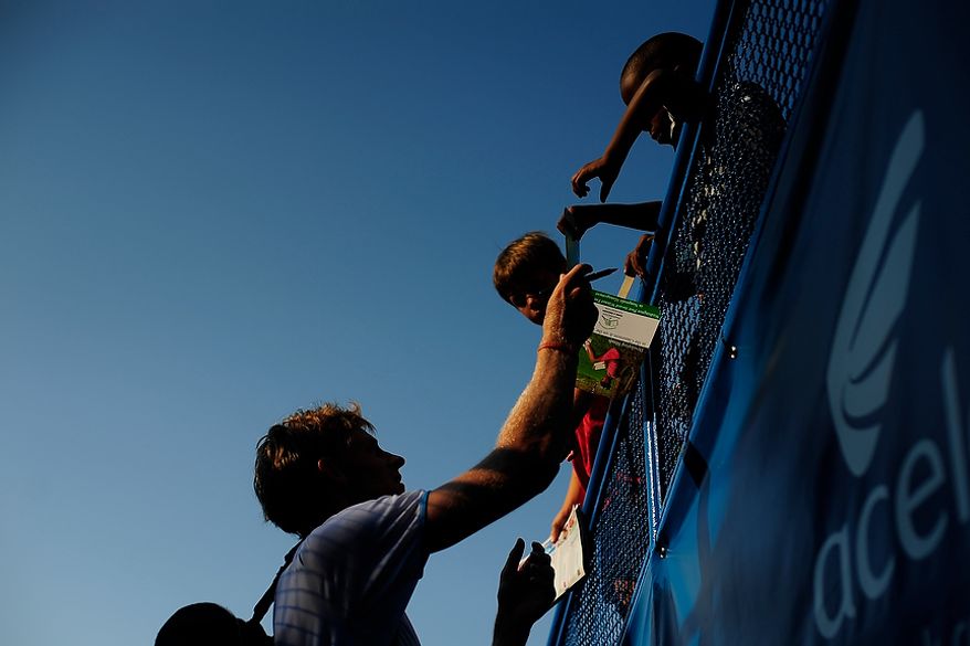 Kevin Anderson signs autographs for fans after defeating Florent Serra at the Citi Open tennis tournament at the William H.G. FitzGerald Tennis Center, Washington D.C., Thursday, August 2, 2012. (Ryan M.L. Young/The Washington Times)