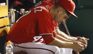 Washington Nationals starting pitcher Gio Gonzalez sits in the dugout in the ninth inning during the second baseball game of a doubleheader against the Miami Marlins, Friday, Aug. 3, 2012, in Washington. The Marlins won 5-2. (AP Photo/Carolyn Kaster)