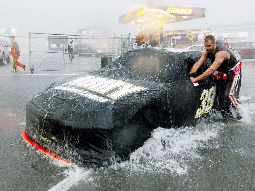 NASCAR’s Sprint Cup Series race Sunday at Pocono Raceway was called after 98 of 160 scheduled laps, giving the win to Jeff Gordon over runner-up Kasey Kahne. The deluge forced all of the cars, including Ryan Newman’s 39, to leave the track. (Associated Press)