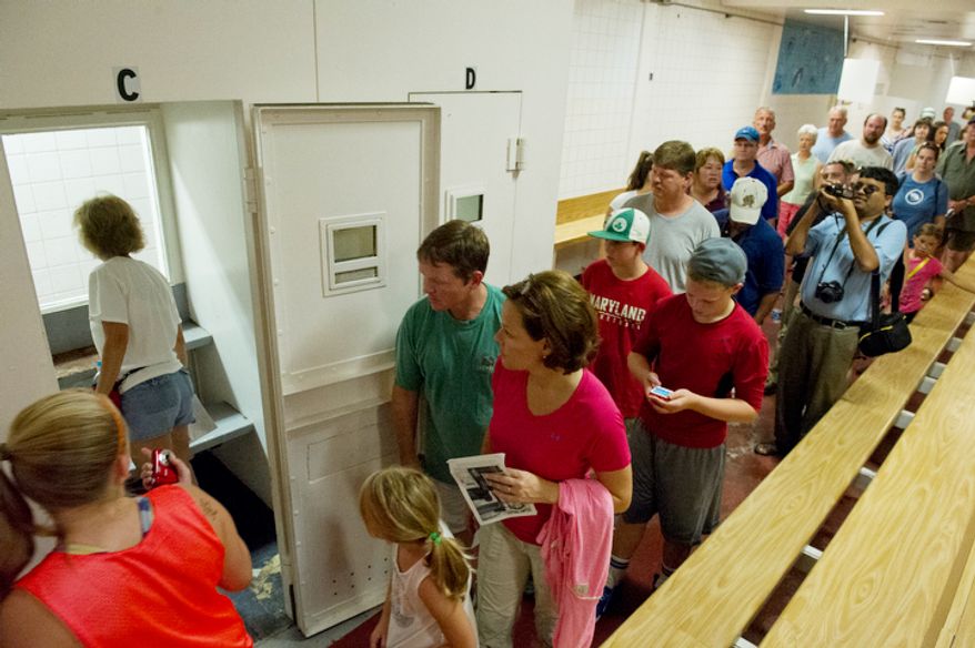 Visitors walk through the visitation room, including taking a look at one of the private visitation rooms, at the Maryland House of Corrections in Jessup, Md. (Barbara L. Salisbury/The Washington Times)
