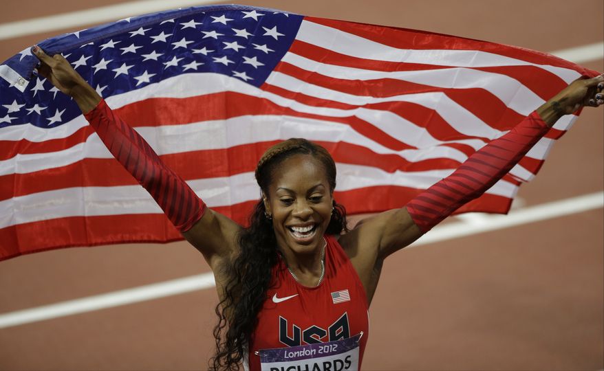 Sanya Richards-Ross of the US waves the national flag after winning a gold medal in the women's 400-meter race during the athletics competition in the Olympic Stadium at the 2012 Summer Olympics, London, Sunday, Aug. 5, 2012. (AP Photo/Matt Slocum)