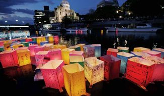 Paper lanterns float along the Motoyasu River in front of the illuminated Atomic Bomb Dome in Hiroshima, on Monday. The 67th anniversary of the day the United States dropped an atomic bomb on the city during World War II was observed. A second bomb dropped on Nagasaki led to Japan’s surrender. (Associated Press)