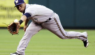 **FILE** Milwaukee Brewers shortstop Cesar Izturis fields a line drive hit by Philadelphia Phillies&#39; Jimmy Rollins to end the second inning of the Phillies&#39; 7-6 home win on July 23, 2012. (Associated Press)