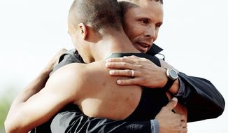 Dan O’Brien embraces Ashton Eaton, the man O’Brien called the “cream of the crop” for the Americans in the decathlon at the London Olympics. O’Brien now serves in the U.S. Olympic Committee’s ambassador program and works with USA Track &amp; Field. (Associated Press)
