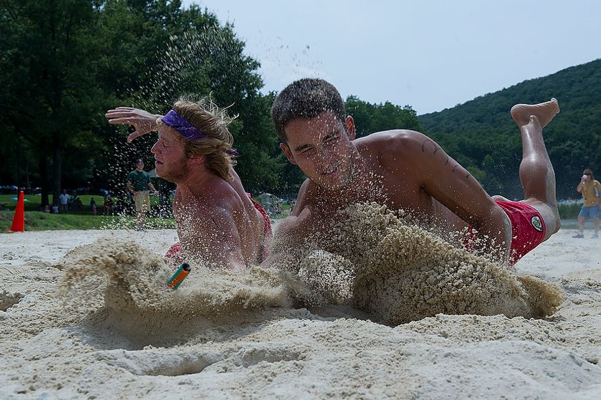 Jay Donoghue, left, of Greenbrier State Park and Michael Diambrosio, who guides for Assateague State Park, vie for the same flag during the beach flag portion of the 23rd annual Lifeguard Competition at Greenbrier State Park in Boonsboro, Md. on Tuesday, Aug. 7, 2012. The events included a 300-yard swim, beach flags, a rescue race, an iron guard relay and an obstacle course. The winners receive a trophy, but most importantly get bragging rights. (Barbara L. Salisbury/The Washington Times)