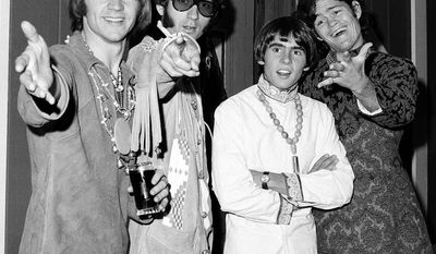 Monkees Peter Tork, Mike Nesmith (from left) and Micky Dolenz (far right) are reuniting for a tour. Davy Jones (second from right) died in February. (Associated Press)