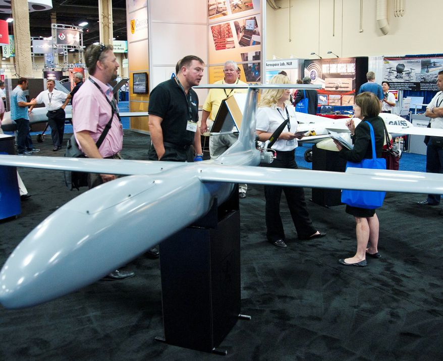 ** FILE ** In this Aug. 8, 2012, file photo, all shapes and sizes of drones fascinate visitors at the Association of Unmanned Vehicles Systems International conference in Las Vegas. (Martin S. Fuentes/Special to The Washington Times)