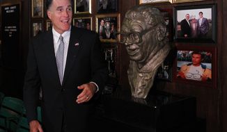 Republican presidential candidate Mitt Romney poses Aug. 7, 2012, with a bust of famed baseball announcer Harry Caray after a private fundraising event at Harry Caray&#39;s Italian Steakhouse restaurant in Chicago. (Associated Press)