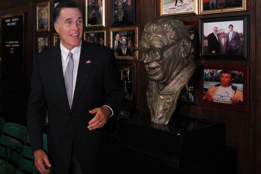 Republican presidential candidate Mitt Romney poses Aug. 7, 2012, with a bust of famed baseball announcer Harry Caray after a private fundraising event at Harry Caray's Italian Steakhouse restaurant in Chicago. (Associated Press)