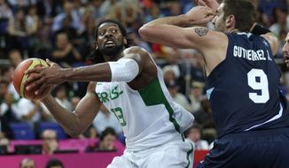 Brazil&#39;s Nene Hilario, drives to the basket against Argentina&#39;s Juan Gutierrez during a men&#39;s quarterfinals basketball game at the 2012 Summer Olympics, Wednesday, Aug. 8, 2012, in London. (AP Photo/Charles Krupa)