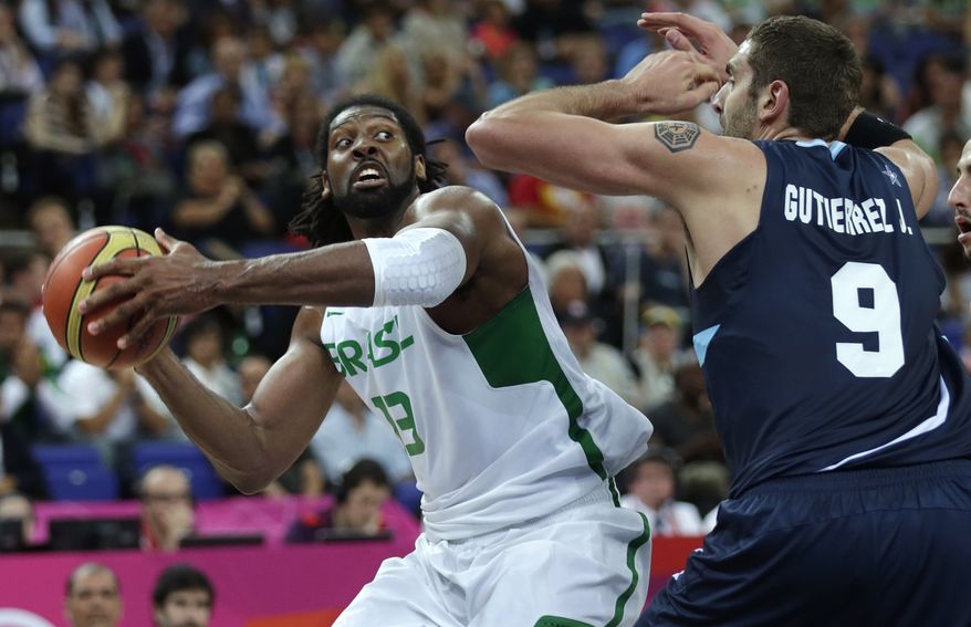 Brazil's Nene Hilario, drives to the basket against Argentina's Juan Gutierrez during a men's quarterfinals basketball game at the 2012 Summer Olympics, Wednesday, Aug. 8, 2012, in London. (AP Photo/Charles Krupa)