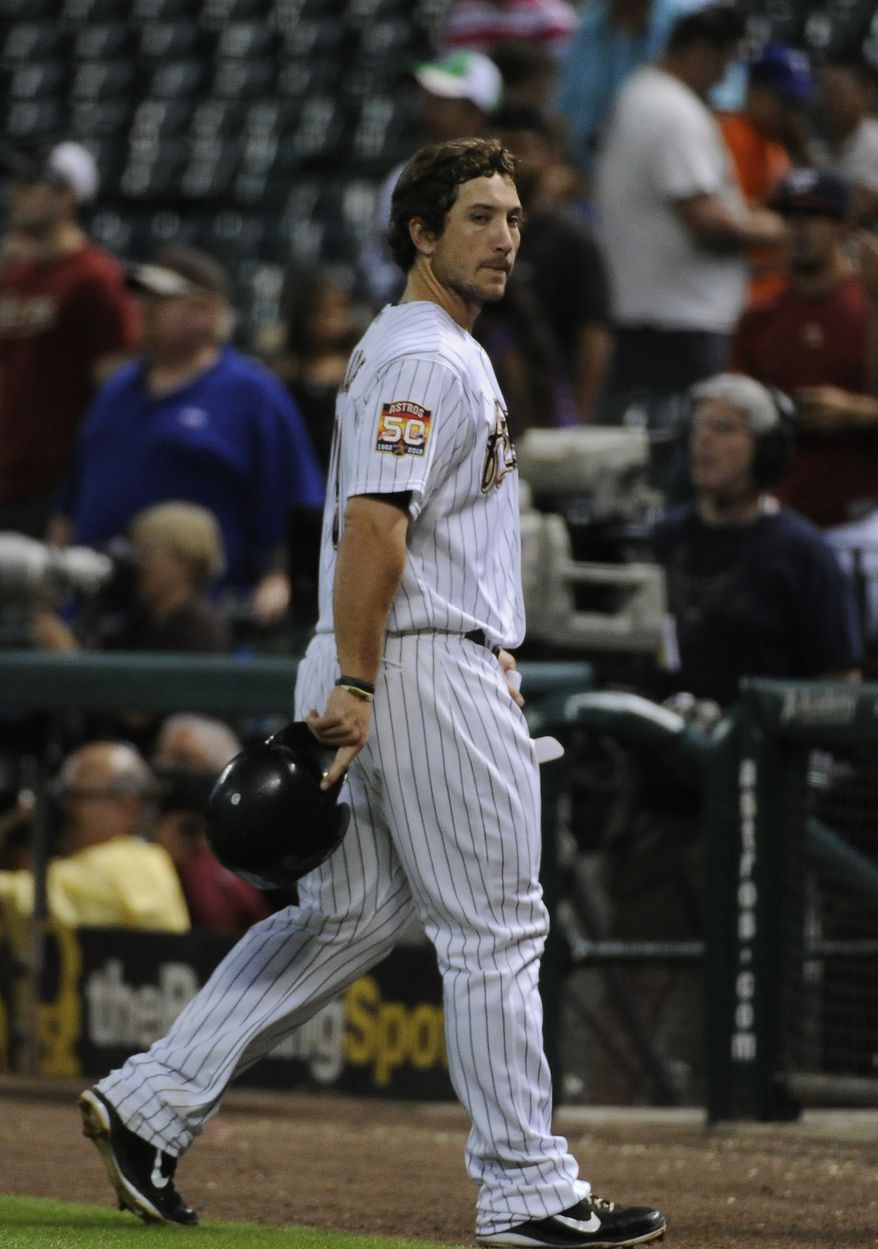 Houston Astros' Brett Wallace walks off the field after flying out with two men on base to give the Washington Nationals a 3-2 win in the 12th inning of a baseball game Tuesday, Aug. 7, 2012, in Houston. (AP Photo/Pat Sullivan)