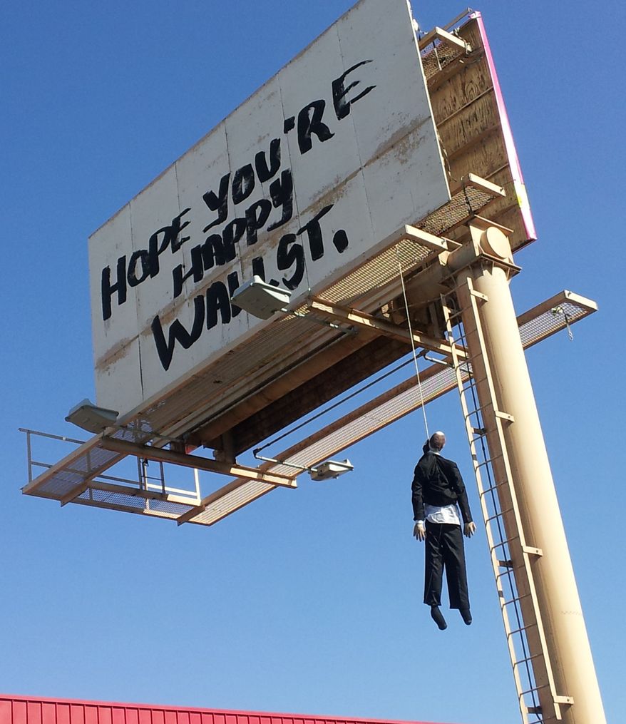 A billboard with a mannequin dangling from a hangman's noose near the Strip in Las Vegas. Authorities said calls began coming in early Aug. 8, 2012, from drivers worried the dummy along Interstate 15 near was a real person. A Nevada Highway Patrol spokesman said the sign is a publicity stunt done in bad taste. (Associated Press/KVVU)