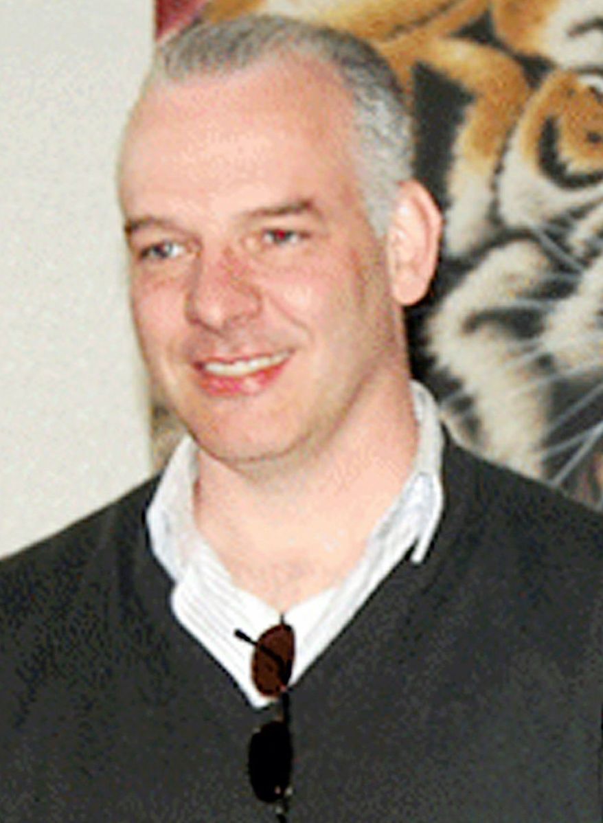 FILE - In this April 12, 2011 file photo, Neil Heywood, a British business consultant, smiles at an art gallery in Beijing. His body was found in a secluded Chongqing hotel in November 2011. Gu Kailai, wife of disgraced politician Bo Xilai, went on trial on a charge of murder of Heywood Thursday, Aug. 9, 2012 at the Hefei Intermediate People's Court in eastern China. (AP Photo/China.org.cn, File)