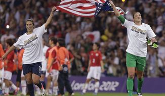 United States&#39; Carli Lloyd, left, and United States goalkeeper Hope Solo celebrate after winning the women&#39;s soccer gold medal match against Japan at the 2012 Summer Olympics, Thursday, Aug. 9, 2012, in London.  The United States won 2-1. (AP Photo/Julie Jacobson)