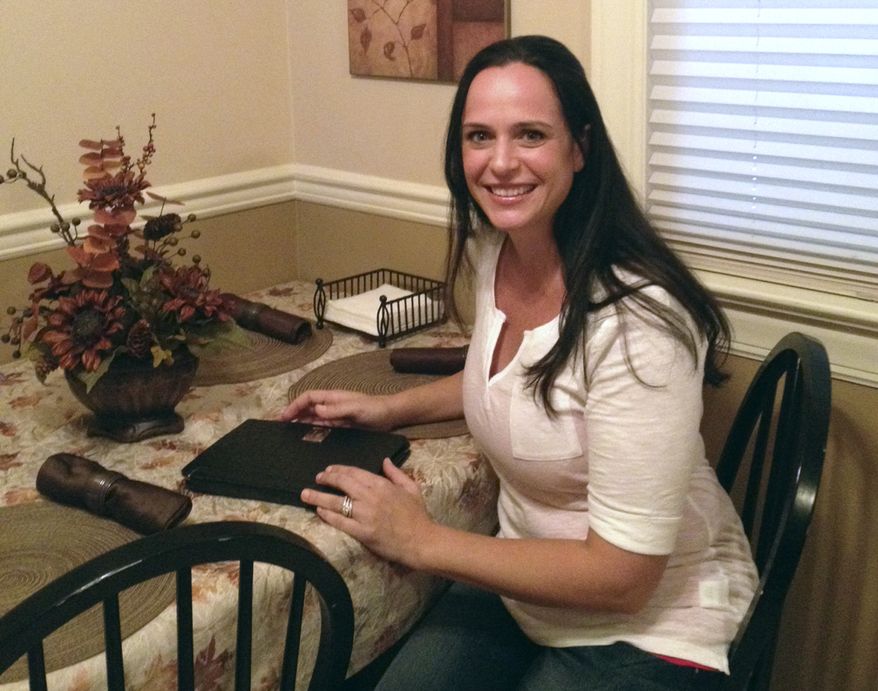 Maryann Sahoury is seen Aug. 9, 2012, in her Wood Ridge, N.J., home. Sahoury is suing a production company after an instructional breast-feeding video she appeared in was taken by a third party and used to create pornography. (Associated Press)