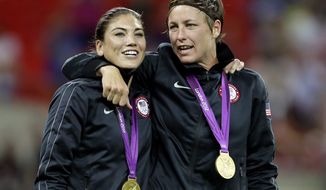 United States&#39; Abby Wambach, right, and teammate Hope Solo celebrate winning the gold medal during in the women&#39;s soccer final against Japan at the 2012 Summer Olympics, Thursday, Aug. 9, 2012, in London. (AP Photo/Kirsty Wigglesworth)