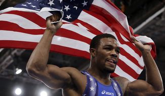 ** File ** United States&#39; Jordan Ernest Burroughs, celebrates after winning against Iran&#39;s Sadegh Saeed Goudarzi after the gold medal match at a 74-kg men&#39;s freestyle wrestling competition at the 2012 Summer Olympics, Aug. 10, 2012, in London. (Associated Press)