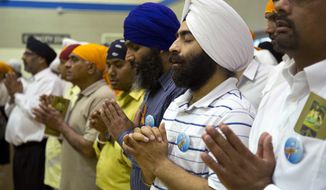 ** FILE ** Mourners attend the funeral and memorial service for the six victims of the Sikh temple of Wisconsin mass shooting in Oak Creek, Wis., on Aug. 10, 2012. (Associated Press)