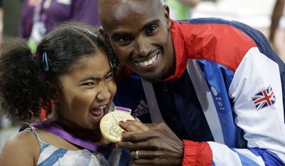 Great Britain&#39;s Mohamed Farah shows off his gold medal to his stepdaughter Rihnna after the awards ceremony for the men&#39;s 5000-meter during the athletics in the Olympic Stadium at the 2012 Summer Olympics, London, Saturday, Aug. 11, 2012. (AP Photo/Matt Slocum)