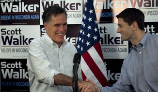 ** FILE ** Republican presidential candidate, former Massachusetts Gov. Mitt Romney, left, shakes hands with U.S. Rep. Paul Ryan, R-Wis., chairman of the House Budget Committee, right, before speaking with supporters of Wisconsin Republican Gov. Scott Walker at a phone bank during a campaign stop in Fitchburg, Wis., in this March 31, 2012, file photo. (AP Photo/Steven Senne, File)

