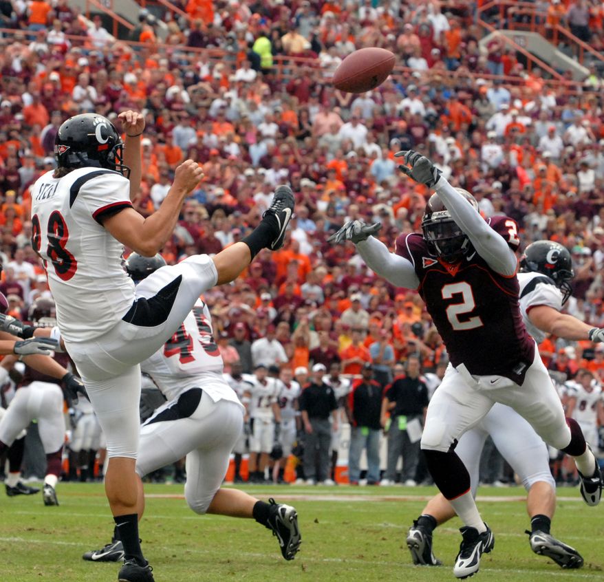 Virginia Tech safety Josh Morgan blocks a punt against Cincinnati's Brian Steel during first quarter action at Lane Stadium in Blacksburg, Va, Saturday Sept. 23, 2006. (AP Photo/Don Petersen)