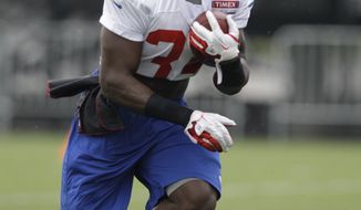 New York Giants running back David Wilson, the Giants 2012 No. 1 draft pick, carries the ball at the New York Giants NFL football training camp in Albany, N.Y., Sunday, July 29, 2012. (AP Photo/Kathy Willens)