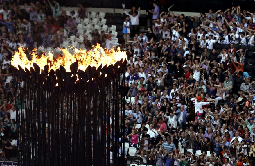 The Olympic flame burns as spectators gather in Olympic Stadium to attend the closing ceremony of the 2012 Summer Olympics on Sunday, Aug. 12, 2012, in London. (AP Photo/Hassan Ammar)