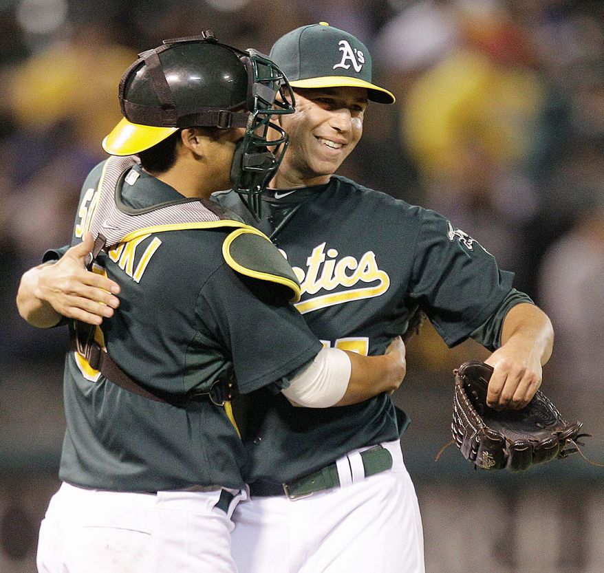 While with Oakland, Kurt Suzuki congratulated Tommy Milone, a former Nationals pitcher who was sent to the Athletics in December in the Gio Gonzalez trade. Suzuki was acquired from Oakland on Aug. 3. (Associated Press)