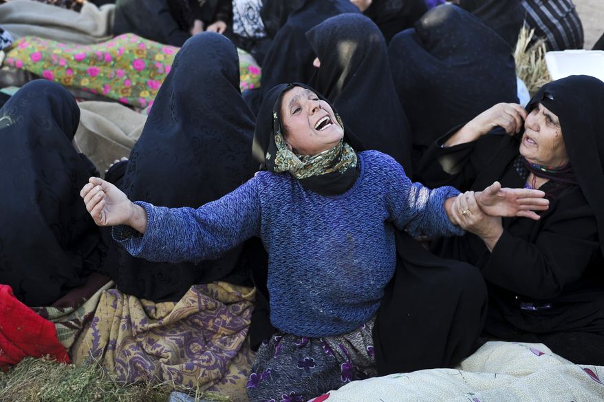 On Sunday, Aug. 12, 2012, an Iranian woman grieves for loved ones who were killed in Saturday&#x27;s earthquake in the village of Bajebaj in northwestern Iran. (AP Photo/ISNA, Arash Khamoushi)