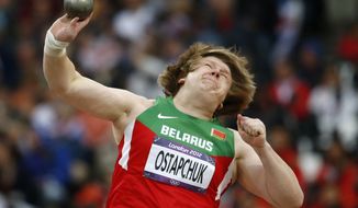 Nadzeya Ostapchuk of Belarus takes a throw in the women&#39;s shot put final at the Olympic Stadium at the 2012 Summer Olympics in London on Monday, Aug. 6, 2012. Ostapchuk became the first athlete to be stripped of a medal at the games after her gold was withdrawn for doping. (AP Photo/Matt Dunham)