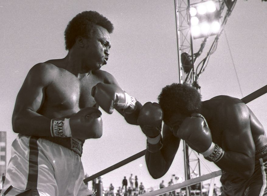 ** FILE ** This May 20, 1983 file photo shows Michael Dokes, left, battling Mike Weaver in a World Boxing Association heavyweight title fight in Las Vegas. The Rhoden Memorial Home in Akron, Ohio, said Dokes died Saturday, Aug. 11, 2012. The Akron Beacon Journal reported that the boxer died in an Akron hospice from liver cancer. He was 54. (AP Photo/File)