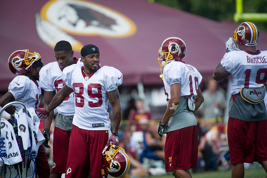Redskins wide receiver Santana Moss (89) takes a break for water during the Redskins training camp at Redskins Park in Ashburn, Va., Monday, August 13, 2012. (Rod Lamkey Jr./The Washington Times)