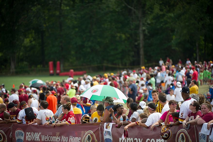 Throngs of people gather along the sideline for a glimpse of the action during the Redskins training camp at Redskins Park in Ashburn, Va., Tuesday, August 14, 2012. This is the last day that fans will be able to watch their team practice in this area. Next year the Redskins will move their practice facility to the Richmond, Va., area. (Rod Lamkey Jr./The Washington Times)
