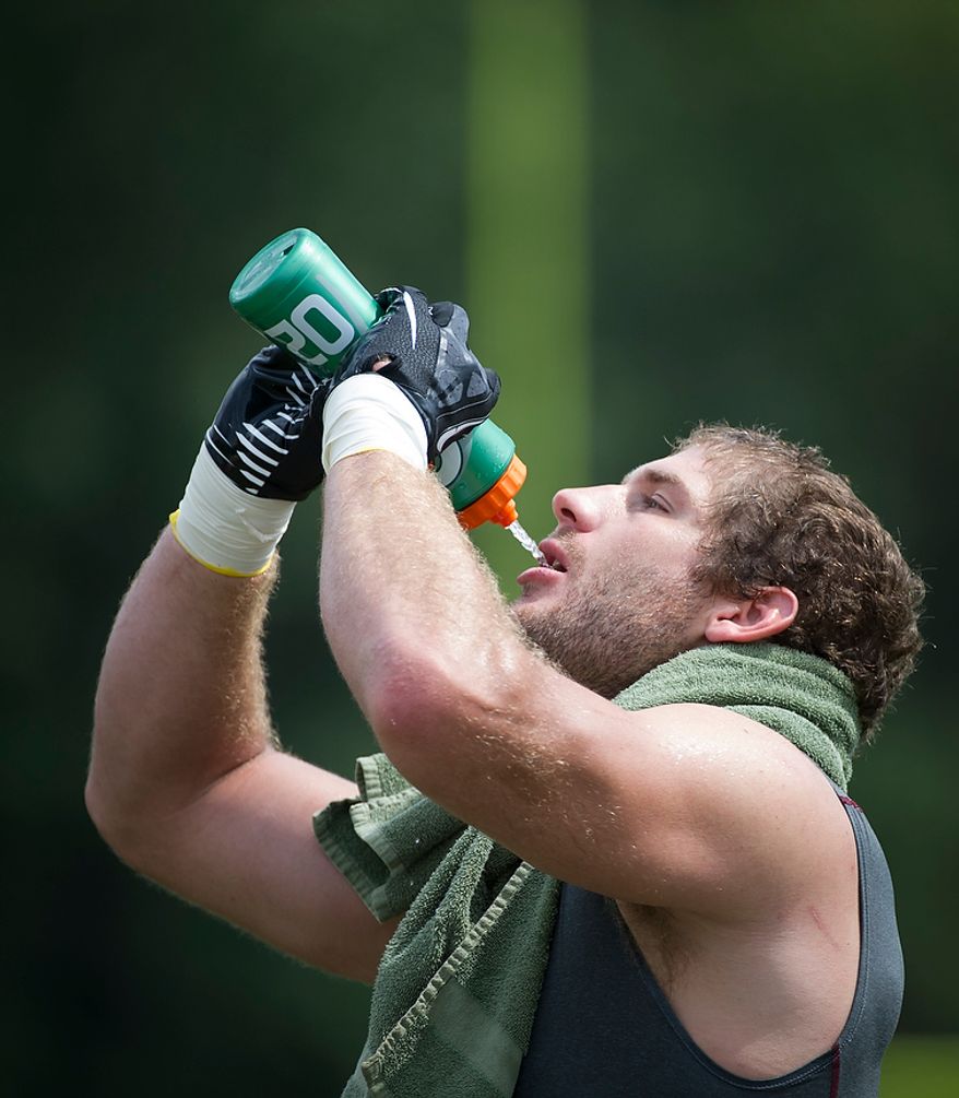 Redskins tight end Chris Cooley takes a drink of water following Redskins training camp at Redskins Park in Ashburn, Va., Tuesday, August 14, 2012. This is the last day that fans will be able to watch their team practice in this area. Next year the Redskins will move their practice facility to the Richmond, Va., area. (Rod Lamkey Jr./The Washington Times)