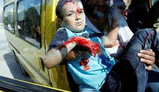 A Syrian boy arrives at a field hospital after an airstrike hit homes on the outskirts of Aleppo on Wednesday. As bloodshed increases in Syria, critics say President Obama has relied too heavily on the United Nations. (Associated Press)
