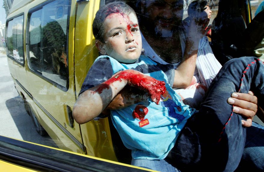 A Syrian boy arrives at a field hospital after an airstrike hit homes on the outskirts of Aleppo on Wednesday. As bloodshed increases in Syria, critics say President Obama has relied too heavily on the United Nations. (Associated Press)
