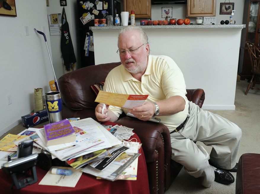 Greg Mann, an unemployed research analyst and real estate appraiser, sorts and cuts coupons at his home Tuesday, Aug. 14, 2012, in Braselton, Ga.. The recession that ended three years ago lingers on as the worst economic recovery since the Great Depression. (AP Photo/John Amis)