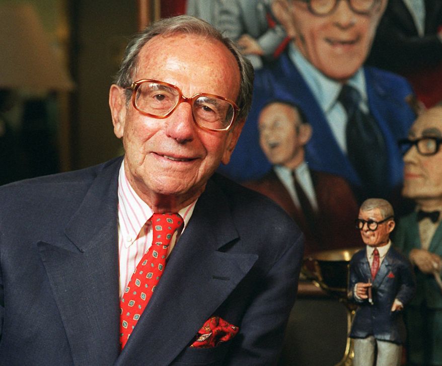 Irving Fein, longtime manager of George Burns and Jack Benny, stands near memorabilia up for auction at Sotheby's in Beverly Hills, Calif., in 1996. (AP Photo/Frank Wiese)