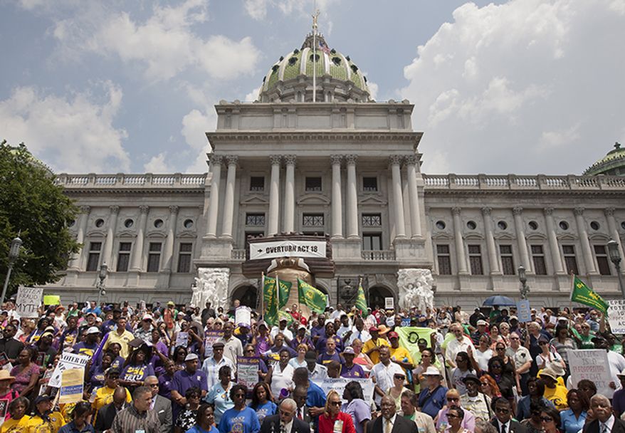 Hundreds of demonstrators descend on the Capitol in Harrisburg, Pa., on Tuesday, July 24, 2012, to protest a tough new voter ID law. (AP Photo/The Harrisburg Patriot-News, John C. Whitehead)