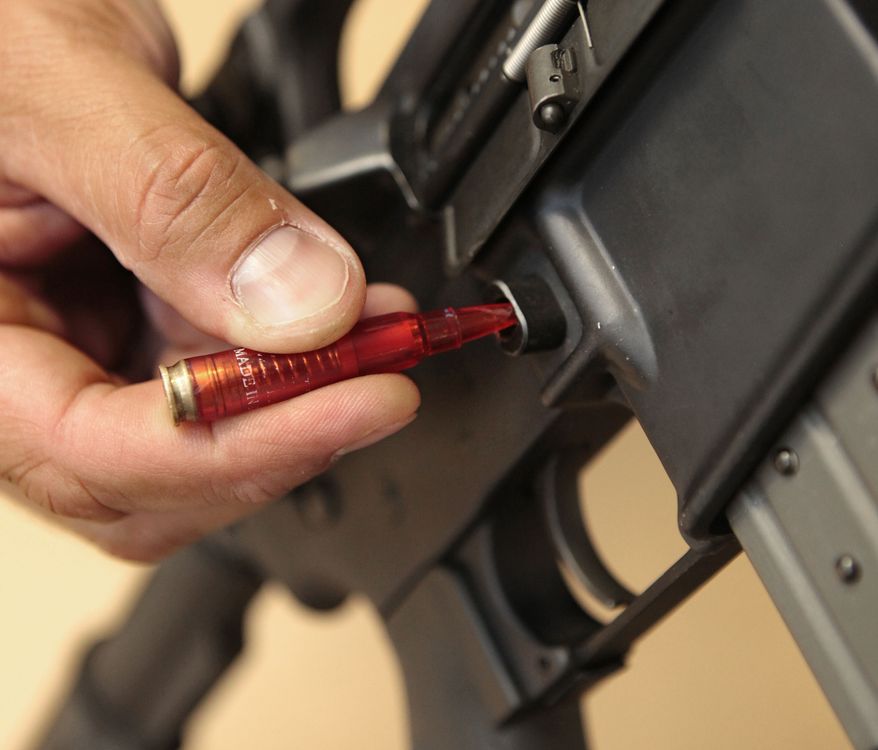 ** File ** A plastic replica of a bullet is used to quickly remove a ammunition magazine from an assault rifle (Associated Press)
