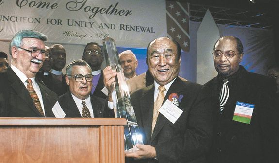  The Reverand Sun Myung Moon accepts an award from special committee of clergy  after he addressed The Inaugural Prayer Luncheon for Unity and Renewal at The Hyatt regency Hotel in Washington, DC, January 19, 2001. ( J.M. Eddins Jr. / The Washington Times )