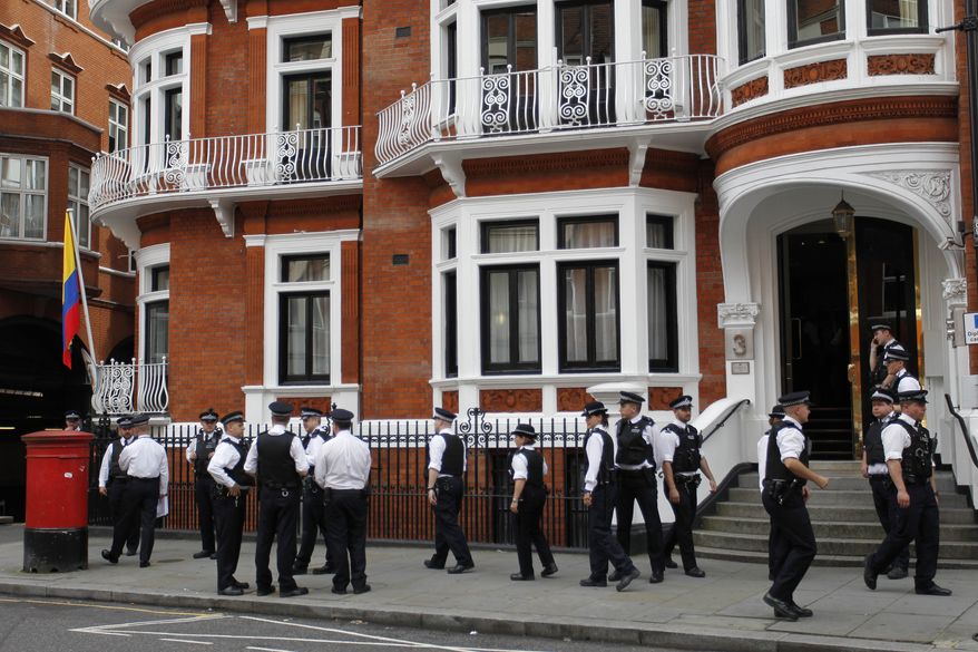 British police officers stand guard outside the Ecuadorian Embassy in central London on Aug. 16, 2012, after Ecuadorean Foreign Minister Ricardo Patino announced that he had granted political asylum to WikiLeaks founder Julian Assange. (Associated Press)