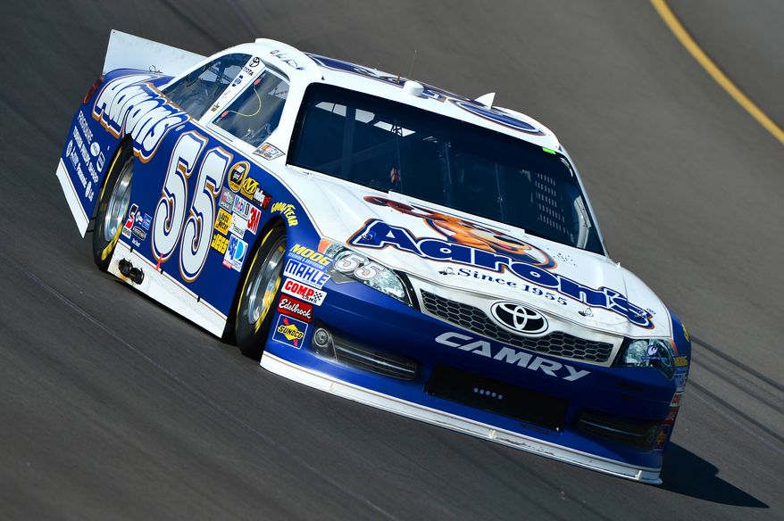 Mark Martin drives through turn one during practice for the NASCAR Sprint Cup Series auto race at Michigan International Speedway on Friday, Aug. 17, 2012 in Brooklyn Mich.. (AP Photo/Autostock, Brian Czobat)