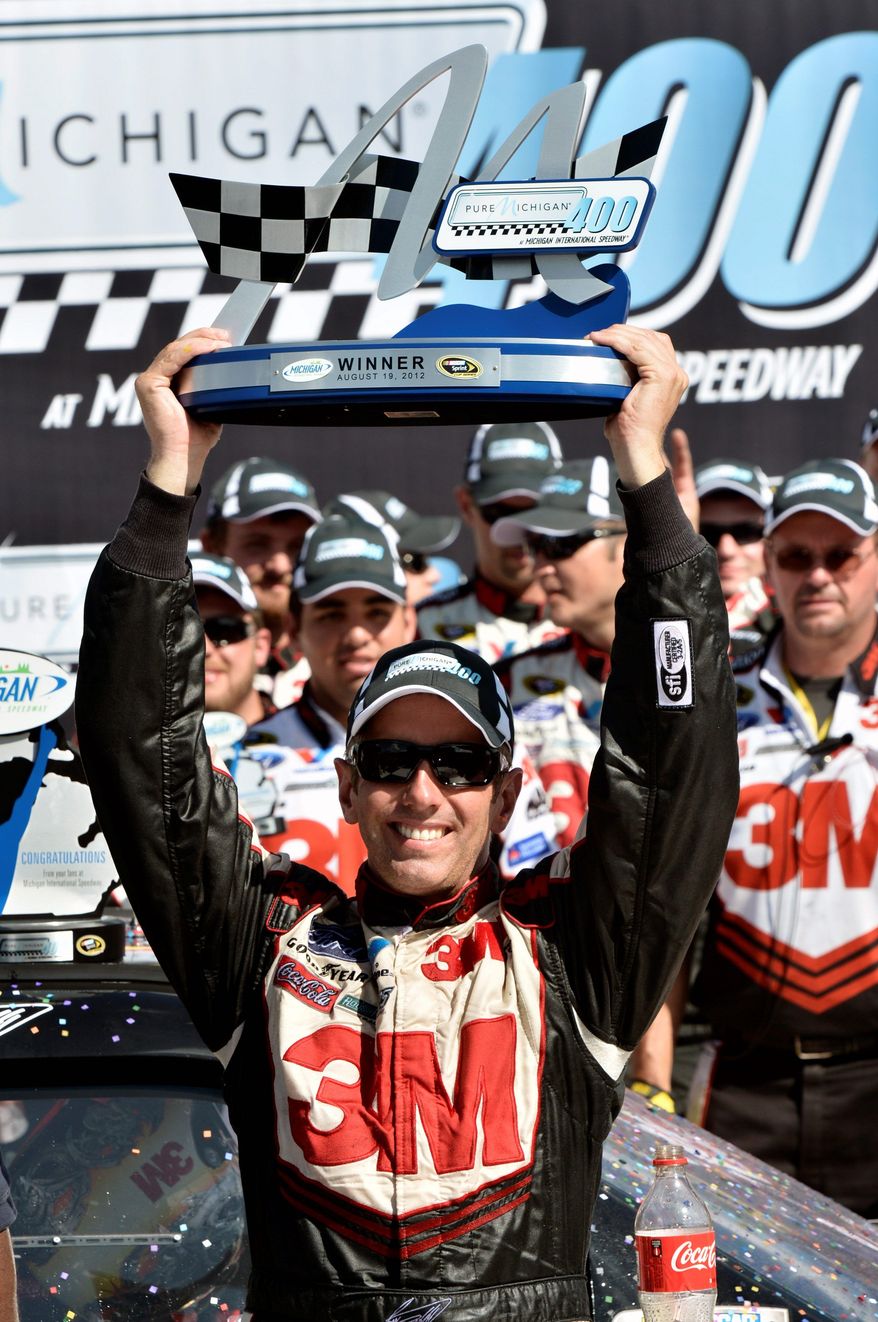 Greg Biffle celebrates Aug. 19, 2012, in Victory Lane after winning the Pure Michigan 400 Race auto race at Michigan International Speedway in Brooklyn Mich. (Associated Press/Autostock)