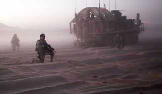 U.S. soldiers from the 5th Stryker Brigade patrol near Spin Boldak, Afghanistan, in August 2009. That October, seven soldiers died when an improvised explosive device blew up a Stryker vehicle. (Associated Press)