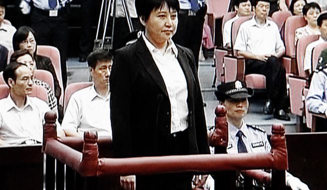 **FILE** Gu Kailai (center), the wife of disgraced politician Bo Xilai, stands during her trial Aug. 9, 2012, in the Hefei Intermediate People&#x27;s Court in Hefei in eastern China&#x27;s Anhui province. The fallen Chinese politician’s wife confessed to killing a British businessman. (Associated Press/CCTV via APTN)